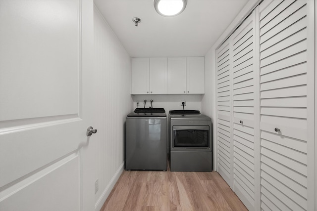 3400 S Ocean Blvd Unit 3Fii, Palm Beach, FL 33480 - washroom with washer and clothes dryer, cabinet space, and light wood-type flooring