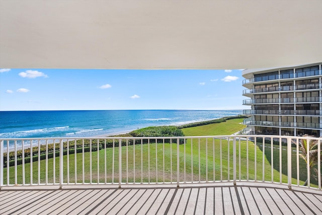 balcony featuring a view of the beach and a water view