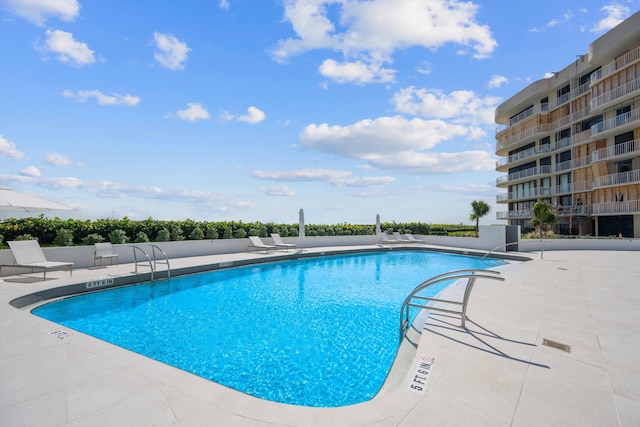 view of swimming pool featuring a patio area