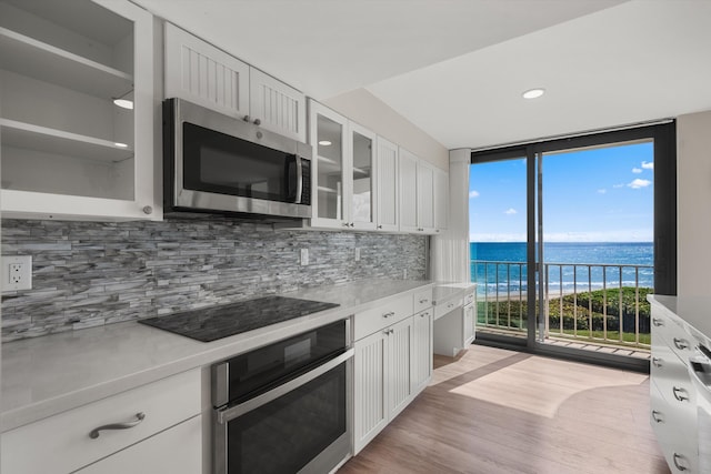 3400 S Ocean Blvd Unit 3Fii, Palm Beach, FL 33480 - kitchen featuring stainless steel appliances, floor to ceiling windows, a water view, decorative backsplash, and light countertops