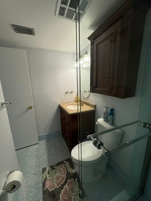 bathroom featuring tile patterned flooring, vanity, and toilet