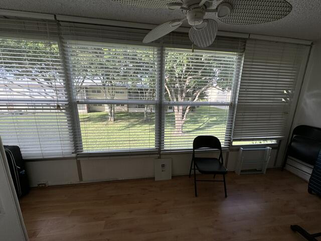 sunroom with ceiling fan and a healthy amount of sunlight