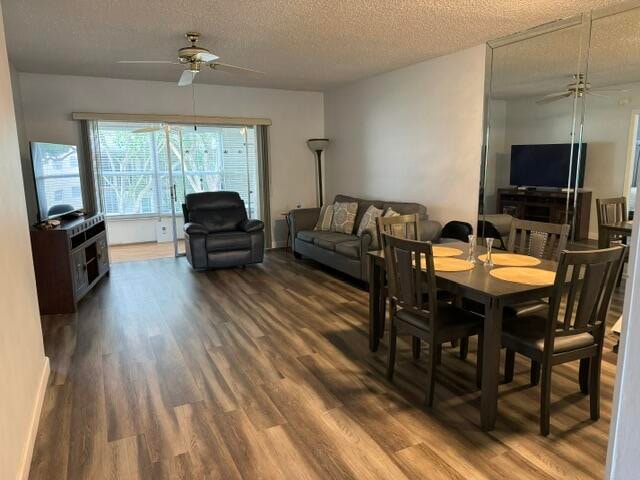 dining room featuring hardwood / wood-style floors, a textured ceiling, and ceiling fan