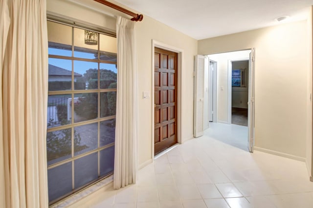 corridor with light tile patterned flooring