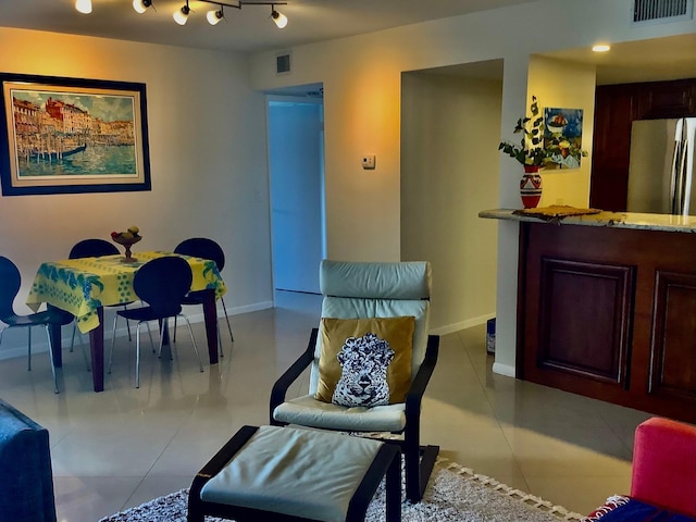 interior space with light tile patterned floors and rail lighting