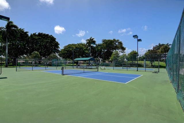 view of tennis court with basketball hoop