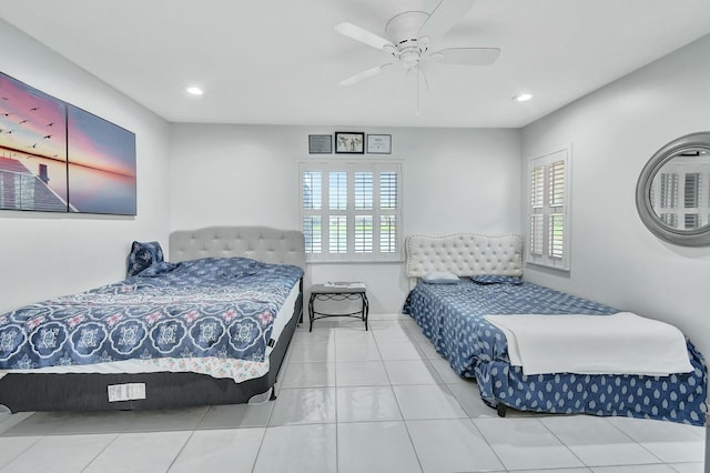 bedroom featuring multiple windows, ceiling fan, and tile patterned flooring