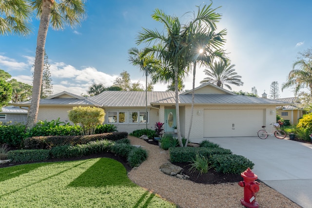 ranch-style house with a front lawn and a garage