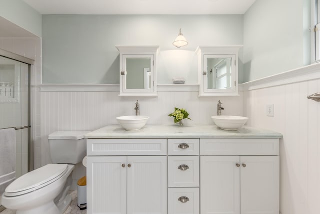 bathroom with vanity, toilet, and an enclosed shower