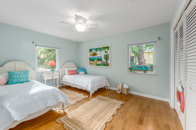 bedroom with ceiling fan, a closet, and light wood-type flooring