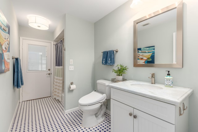 bathroom with tile patterned floors, vanity, and toilet