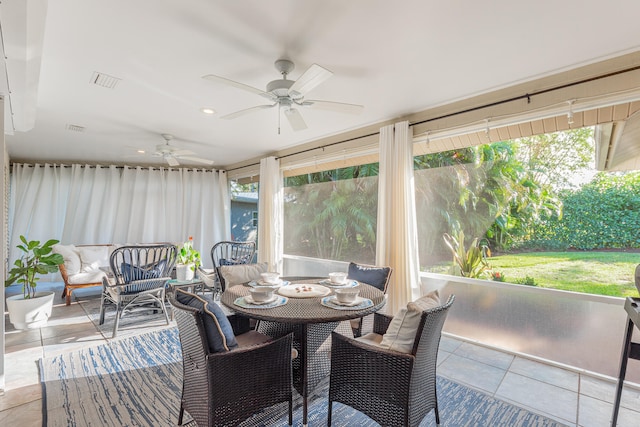 sunroom with a wealth of natural light and ceiling fan