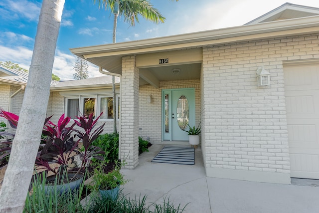 doorway to property with a garage