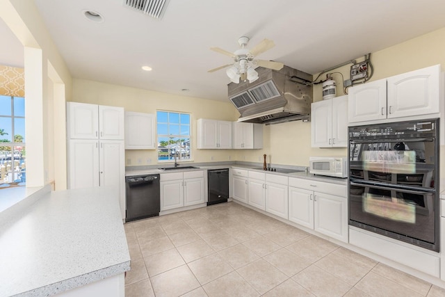 kitchen featuring island range hood, ceiling fan, sink, black appliances, and white cabinetry