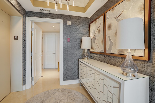 interior space featuring a tray ceiling and ornamental molding