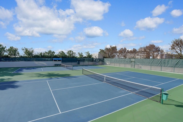 view of tennis court featuring basketball hoop