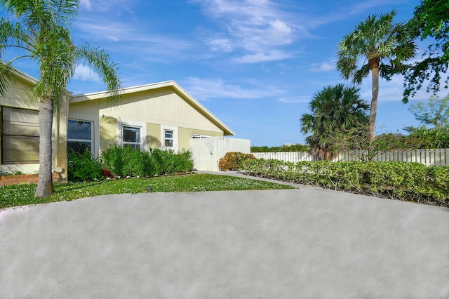 rear view of house featuring a lawn and a sunroom