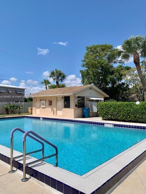 view of swimming pool featuring an outbuilding