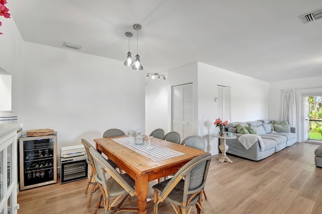 living room with a chandelier and light hardwood / wood-style flooring