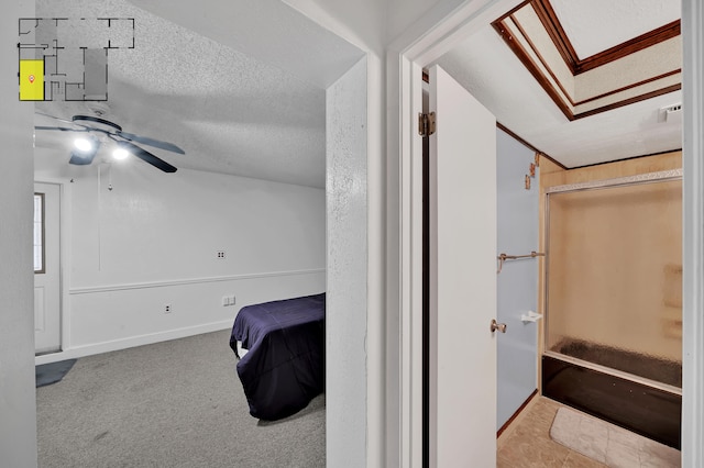 carpeted bedroom with a textured ceiling and ceiling fan