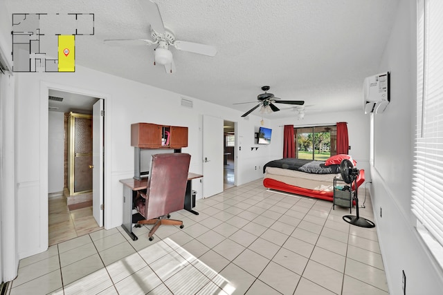 tiled bedroom with a wall unit AC, ceiling fan, and a textured ceiling