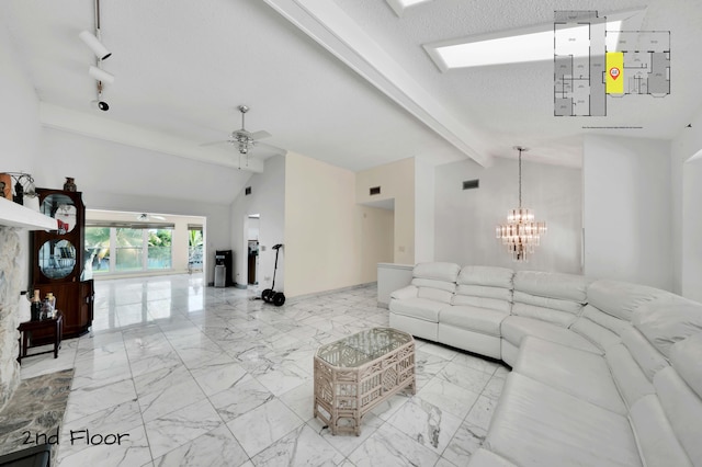 living room with a textured ceiling, lofted ceiling with beams, and ceiling fan with notable chandelier