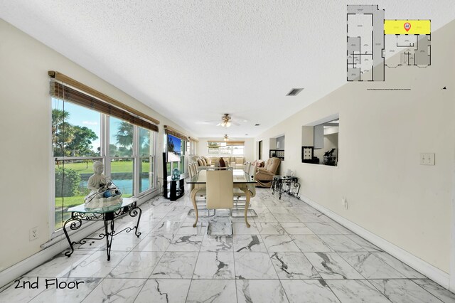 dining area with a textured ceiling and ceiling fan