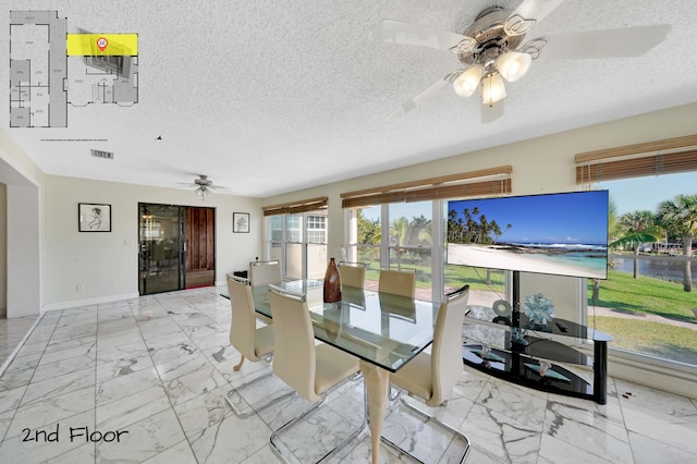 dining room featuring ceiling fan and a textured ceiling