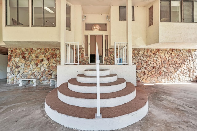 staircase featuring concrete floors