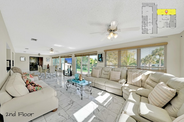 living room featuring a textured ceiling, plenty of natural light, and ceiling fan