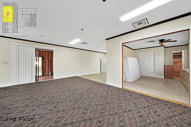 spare room featuring ceiling fan, light colored carpet, and ornamental molding