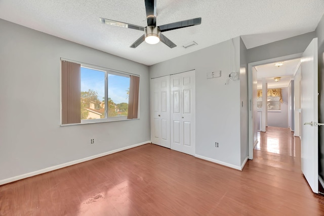 15230 SW 58th St, Miami, FL 33193 - unfurnished bedroom featuring wood-type flooring, a textured ceiling, a closet, and ceiling fan