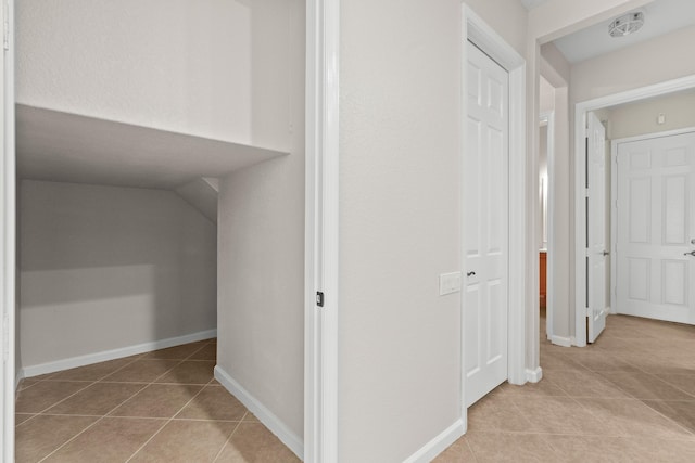 corridor with light tile patterned floors