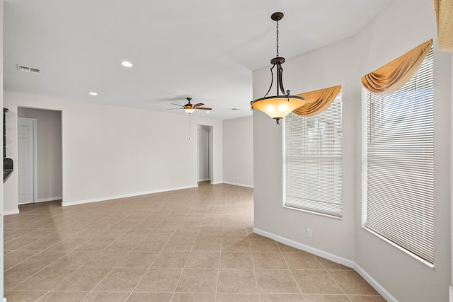 unfurnished room featuring ceiling fan and light tile patterned floors