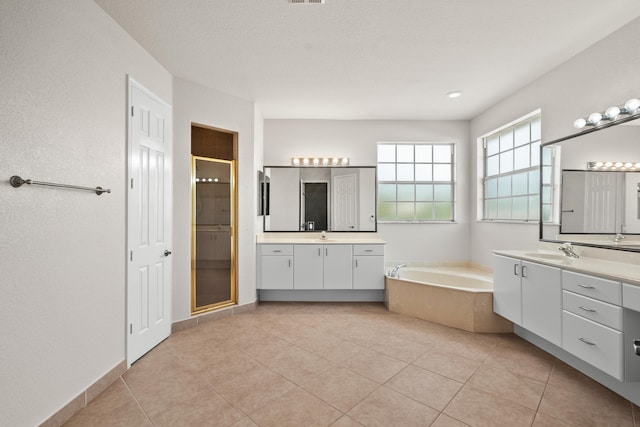 bathroom featuring separate shower and tub, vanity, and tile patterned floors