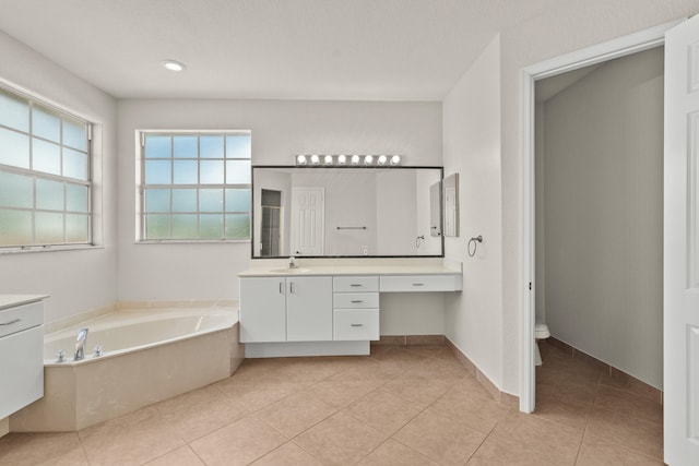 bathroom with toilet, tile patterned floors, a bathtub, and vanity