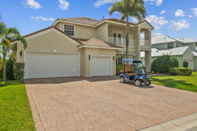 view of front of property featuring a garage and a balcony