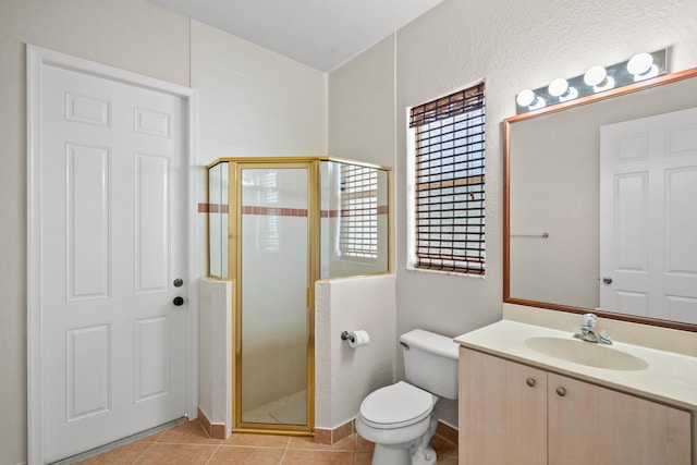 bathroom with vanity, toilet, tile patterned flooring, and a shower with door