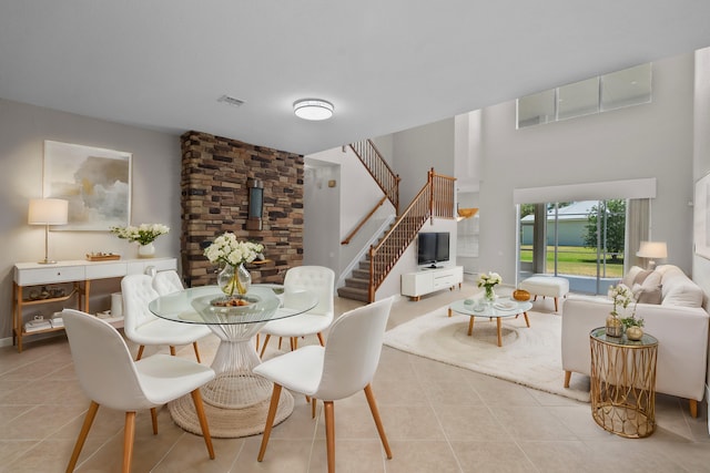 dining room featuring light tile patterned floors and a wood stove