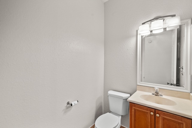 bathroom with toilet and vanity