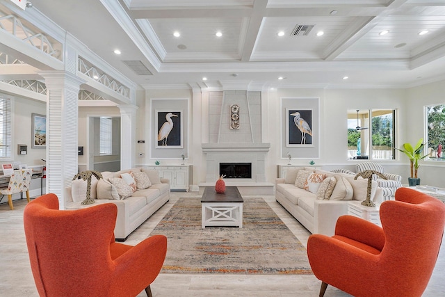 living room featuring coffered ceiling, decorative columns, a large fireplace, ornamental molding, and beamed ceiling