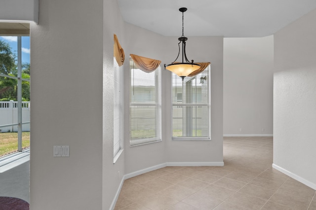 unfurnished dining area with light tile patterned floors