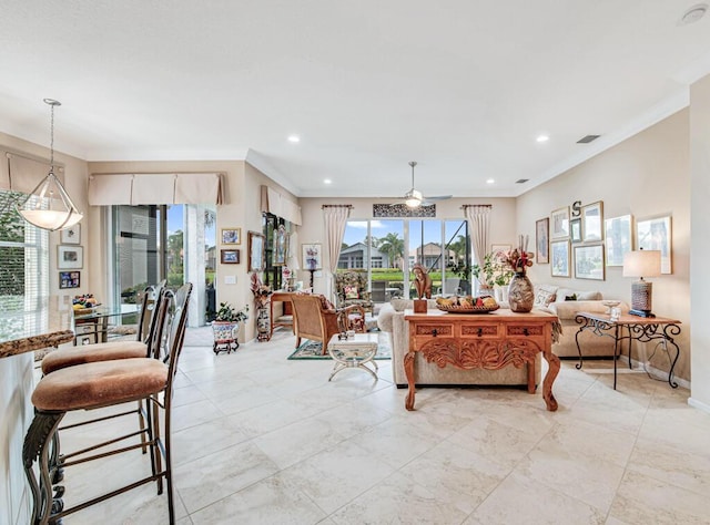 living room featuring ceiling fan and ornamental molding