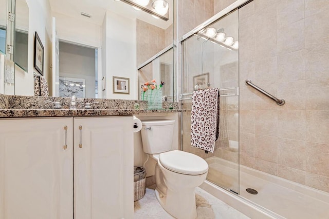 bathroom with vanity, an enclosed shower, and toilet