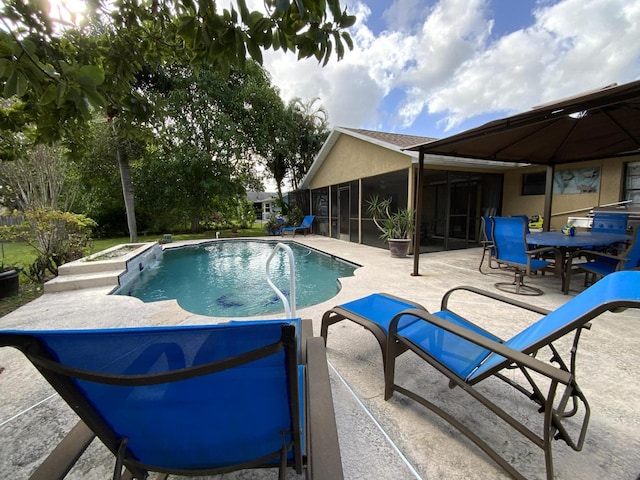 view of pool with a sunroom and a patio area