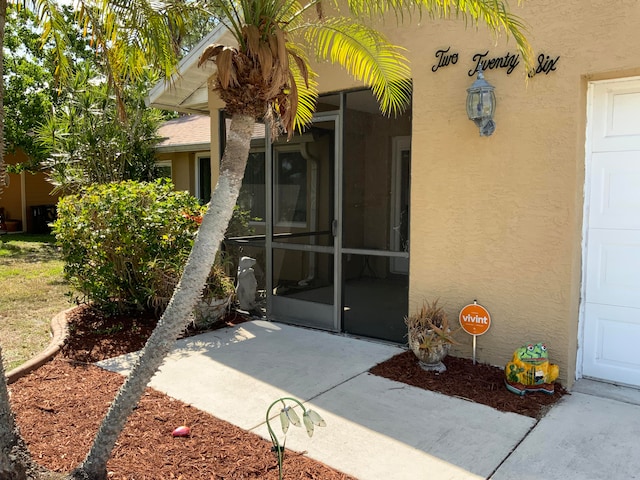 property entrance featuring a patio area