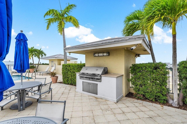 view of patio featuring area for grilling and a pool