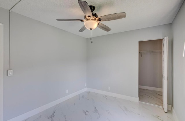 unfurnished bedroom with a textured ceiling, a closet, and ceiling fan