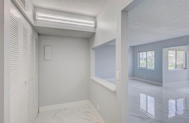 corridor featuring a textured ceiling