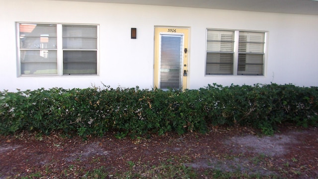 1225 NW 21st St Unit 3506, Stuart, FL 34994 - doorway to property featuring stucco siding